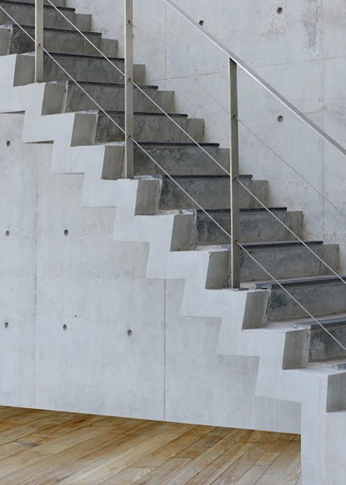 Concrete Staircase with concrete wall and wooden floor out of building